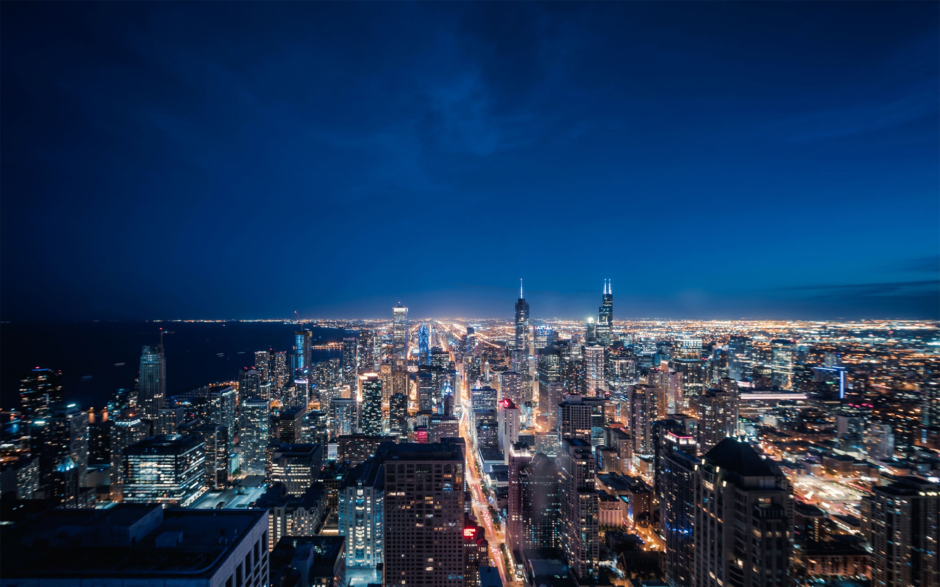 http://cityzguide.com/wp-content/uploads/2021/01/1160442138-Aerial-View-of-Chicago-cityscape-skyline-at-Night.jpg